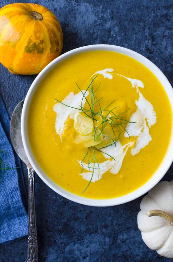 a bowl of creamy Butternut Squash Soup with cream and fennel.