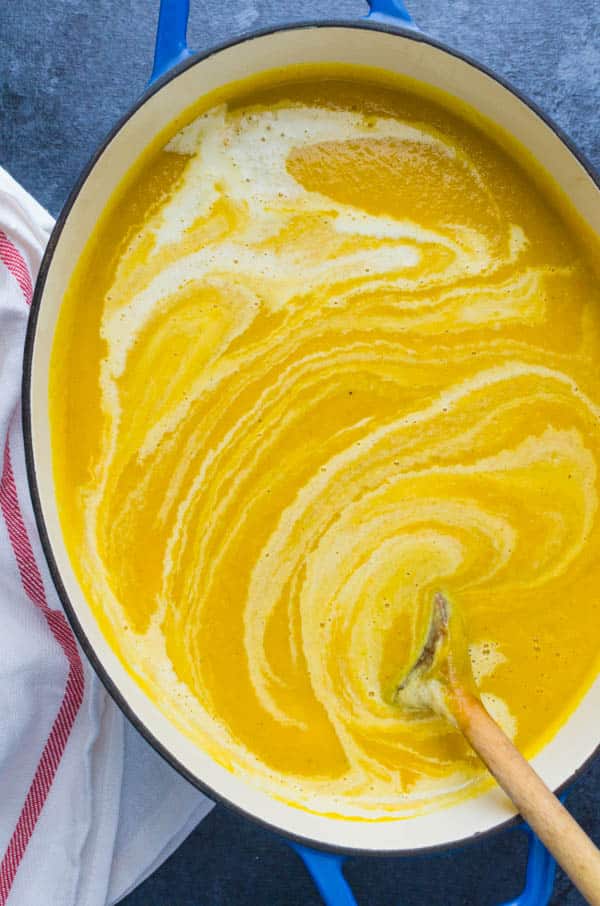 creamy Butternut Squash Soup with a swirl of cream.