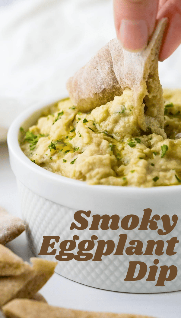smoky eggplant dip being scooped with a pita chip.