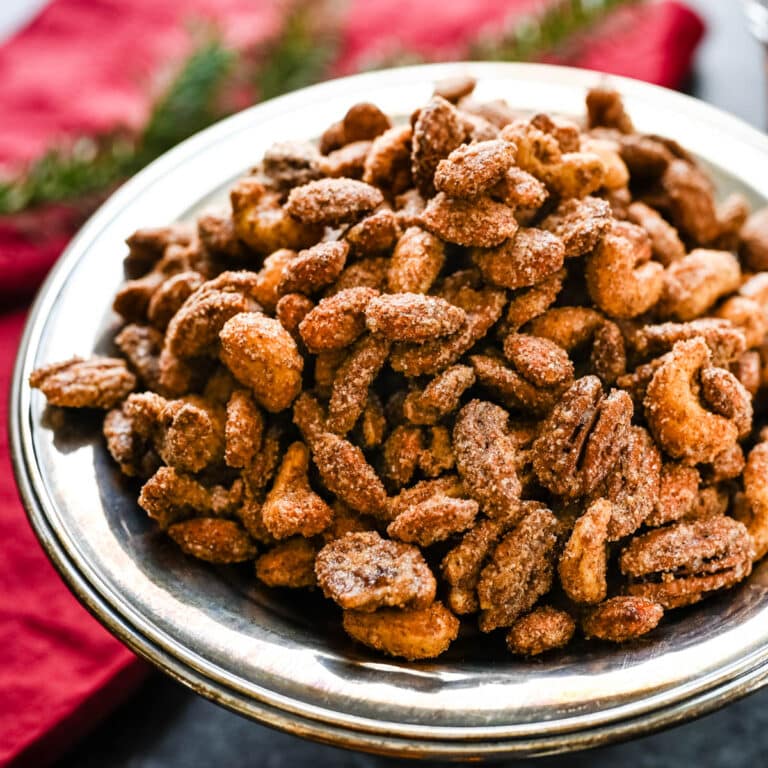 Serving Christmas spiced nuts at a holiday party.
