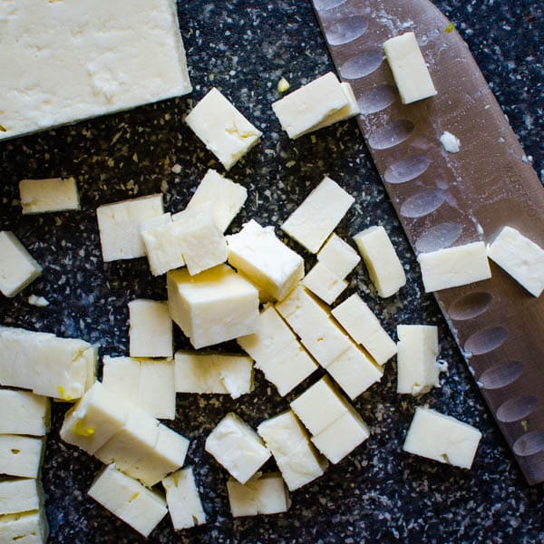 cutting feta cheese for the leftover chicken salad.