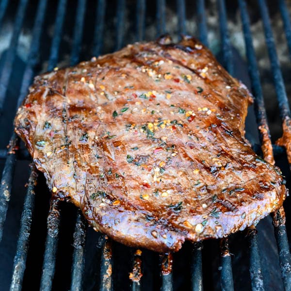 marinated grilled flank steak just before coming off the grill.