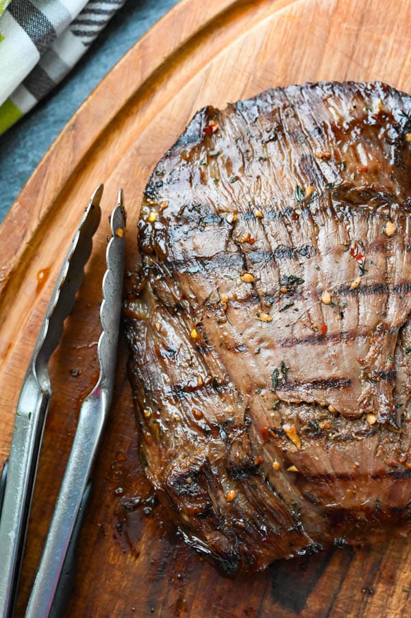 easy flank steak resting on a cutting board.