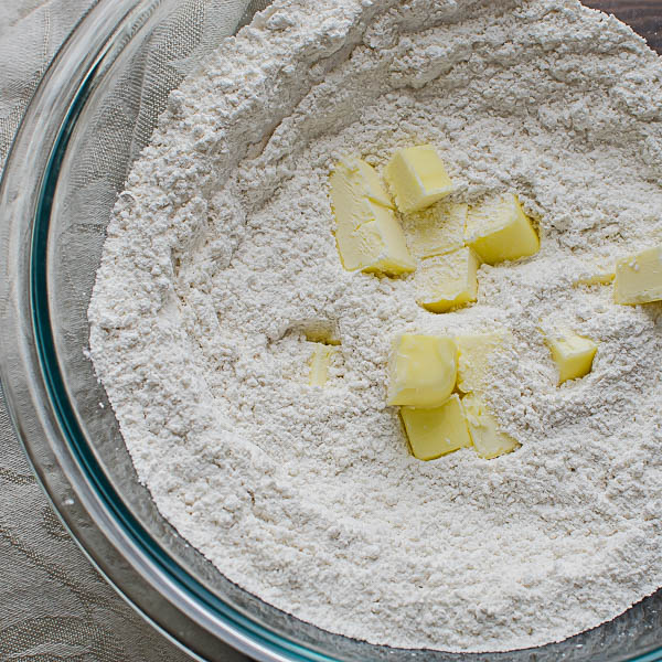 adding butter to flour.