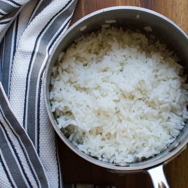 a pot of cooked rice and a dish towel.
