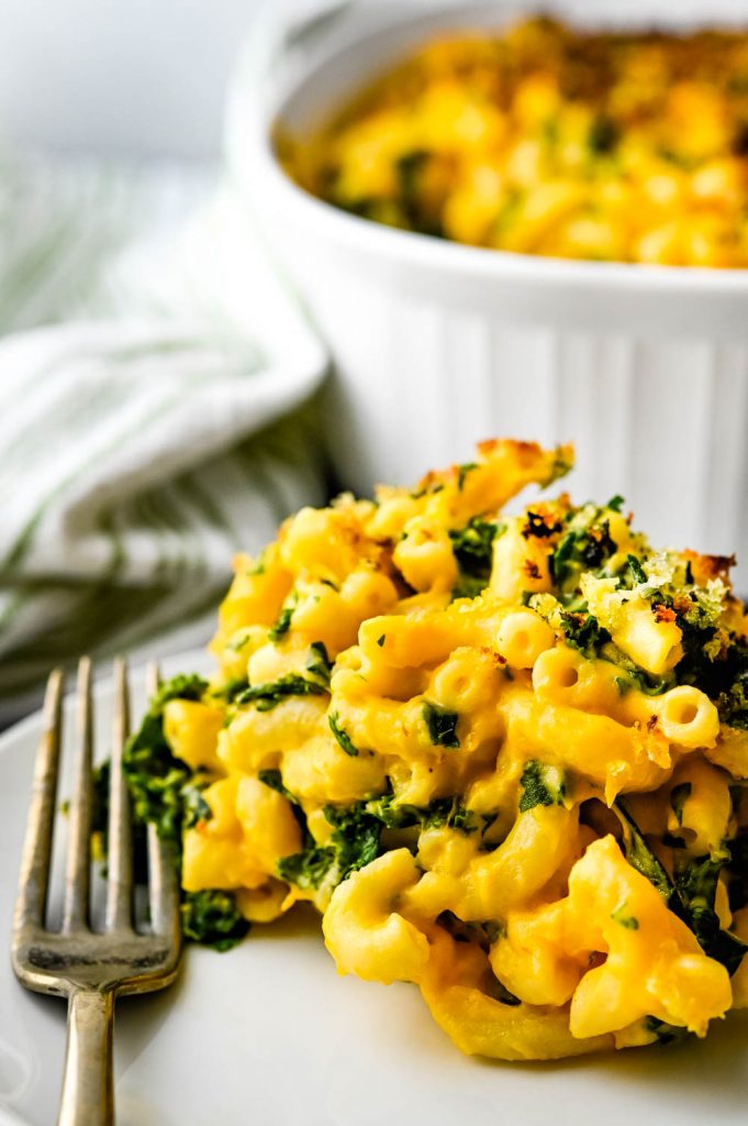Serving creamy healthy mac and cheese on a plate.