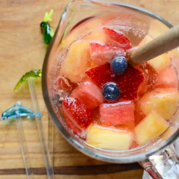 Summer Sipper Sangria in a pitcher with blueberries.