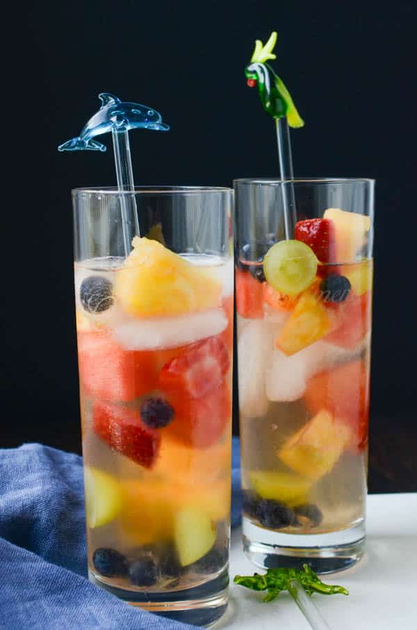 Summer Sipper Sangria in tall glasses with swizzle sticks.