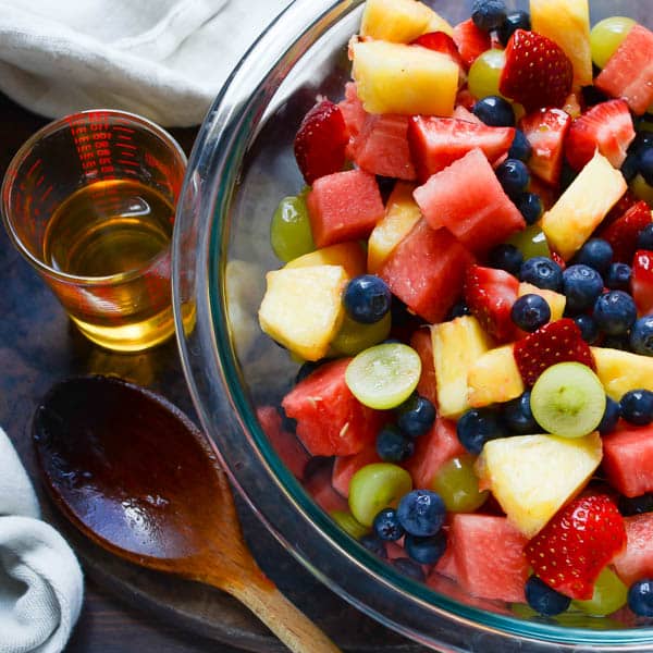 triple sec and rum simple syrup with a fruit bowl.