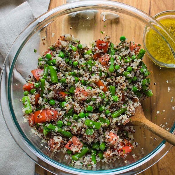 adding quinoa to salad