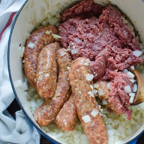 ground beef and italian sausage with onions in pot