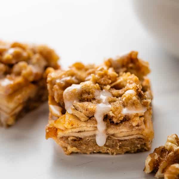 apple bars with oatmeal streusel and glaze. dripping down.