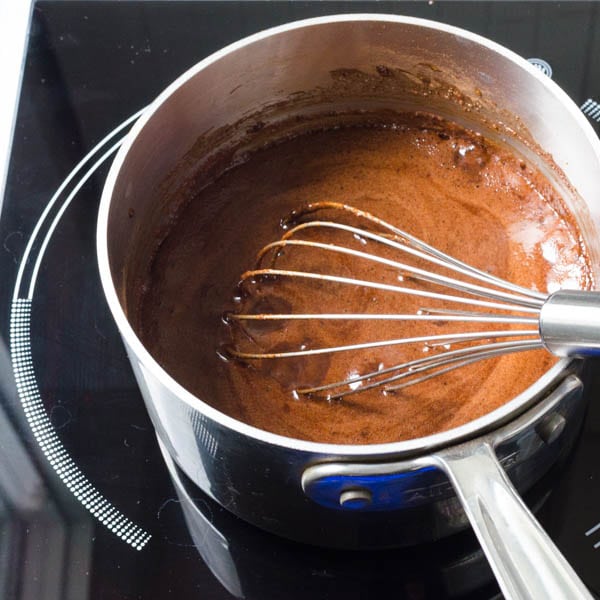 Dark Chocolate Mint Sauce ingredients being whisked in a pot