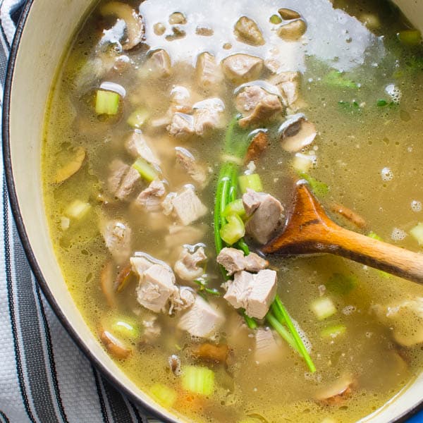 turkey and stock in a pot with vegetables.