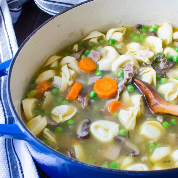 Tuscan Turkey Tortellini Soup with wooden spoon