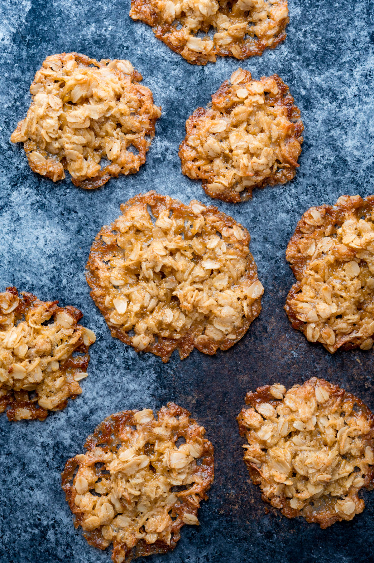 chewy oatmeal coconut cookies on a back board.