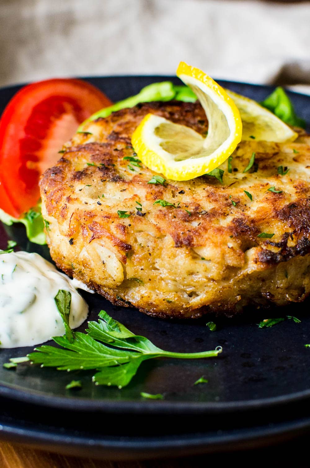 Northern Neck Crab Cakes with tartar sauce and lemon.