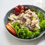 Loaded Chicken Waldorf Salad on a bed of greens.