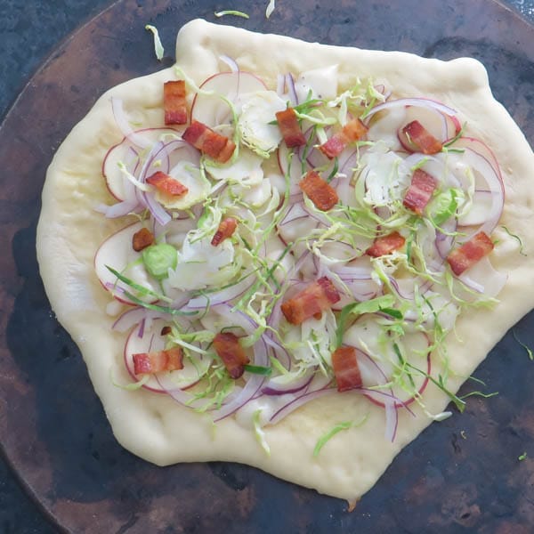 building pizza on a pizza stone.