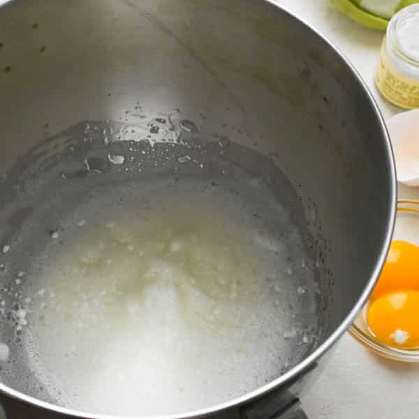 adding cream of tartar to beaten egg whites for vanilla meringue cookies.