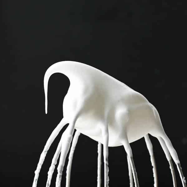 Meringue on the head of a whisk.