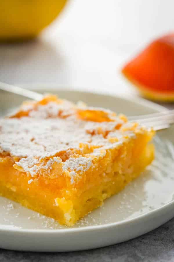 serving citrus bars on a plate.