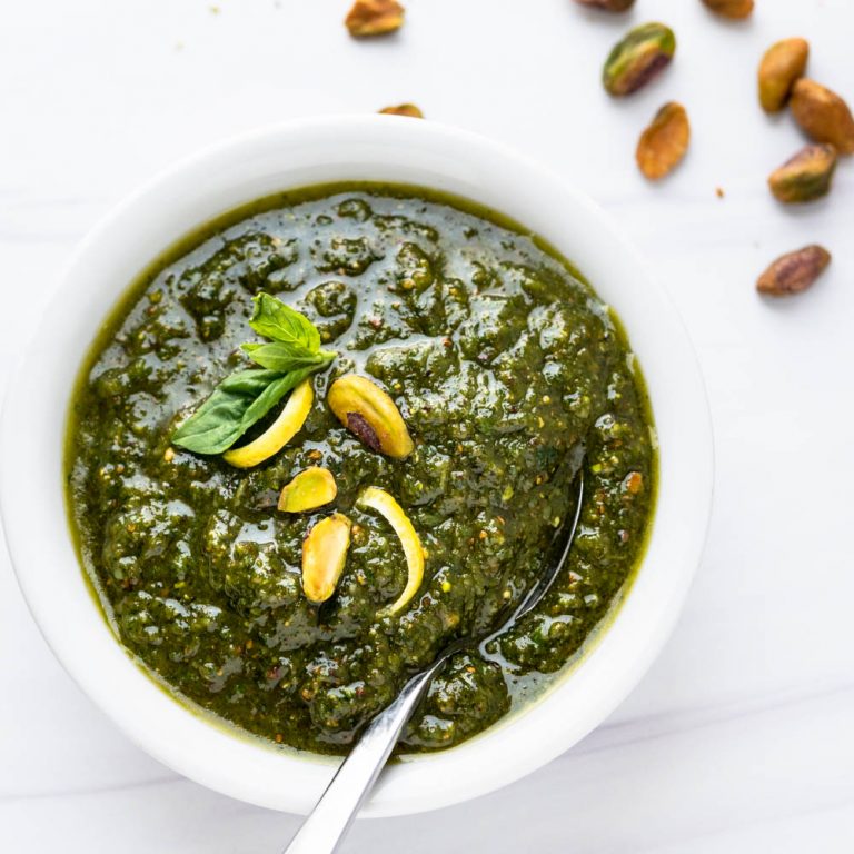 a bowl of pistachio pesto with extra nuts.