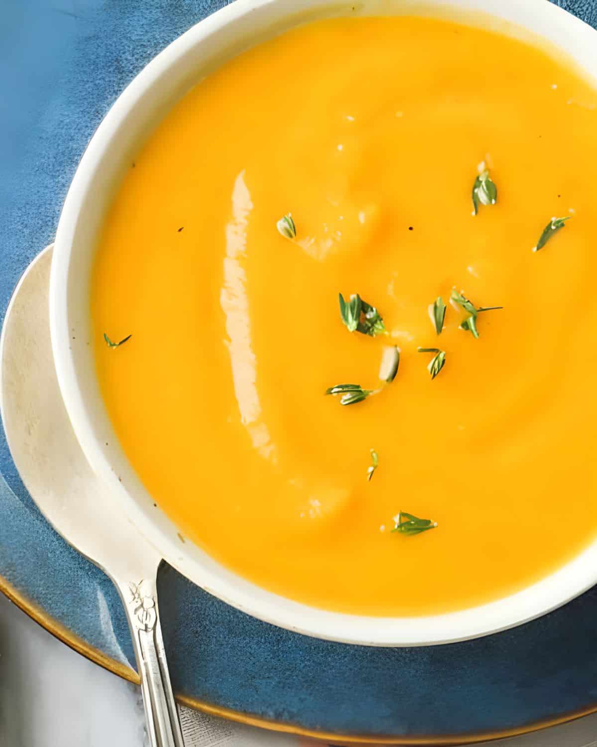 A bowl of creamy carrot soup.