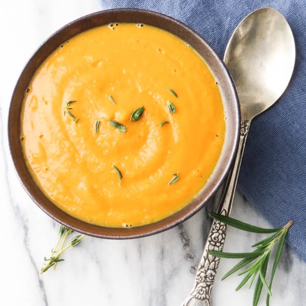 Curried Carrot and Parsnip Soup with a spoon.