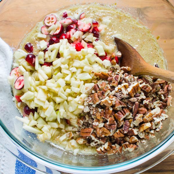 adding fruit and nuts to wet ingredients.