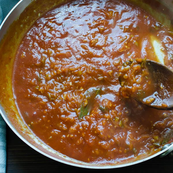 tomato sauce in a pan with spoon