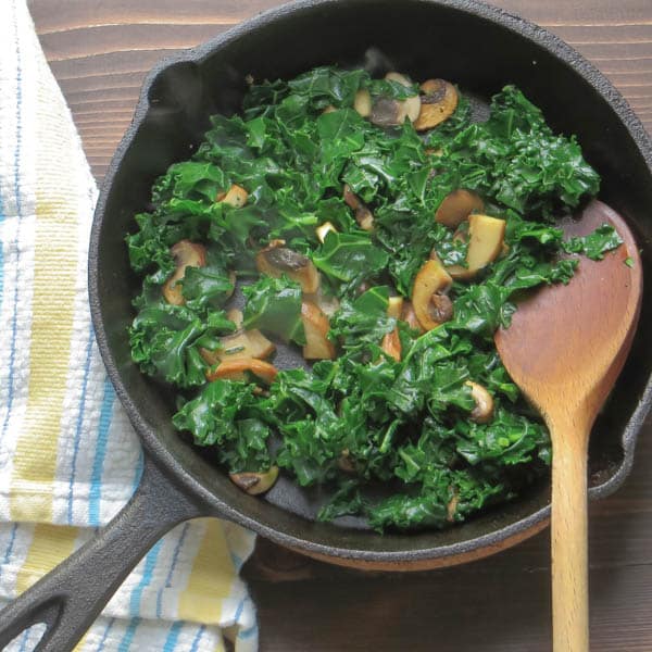 kale and mushroom in a skillet