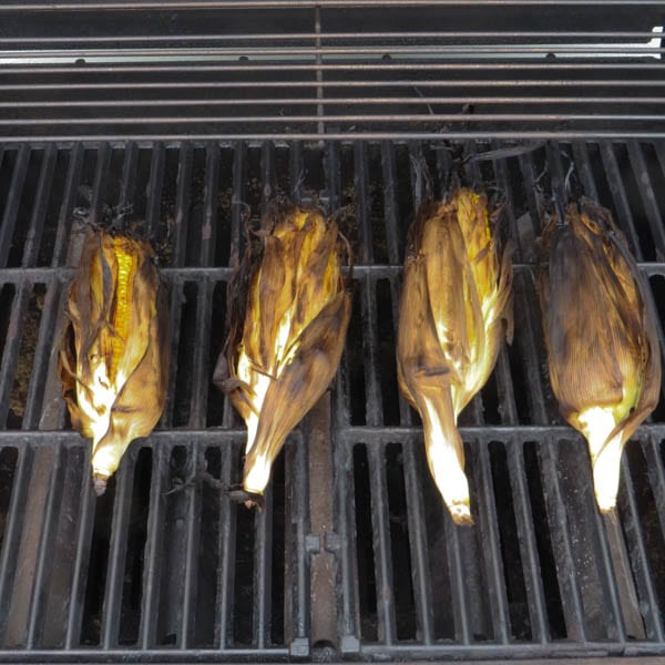 corn in the husks on the hot grill.