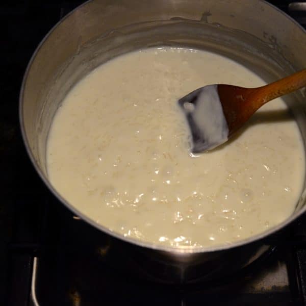 rice pudding in a pot with wooden spoon
