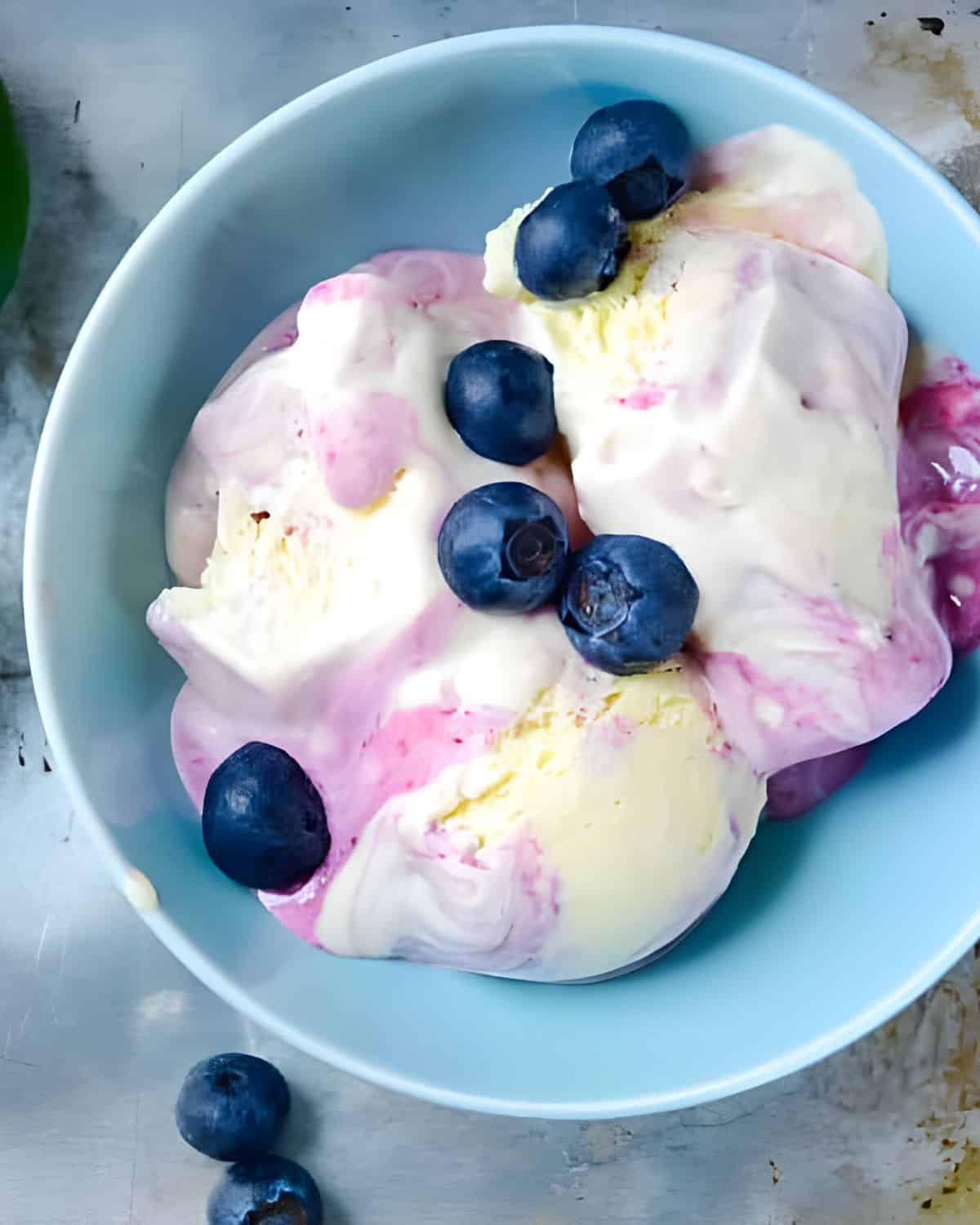 A bowl of blueberry key lime ice cream.
