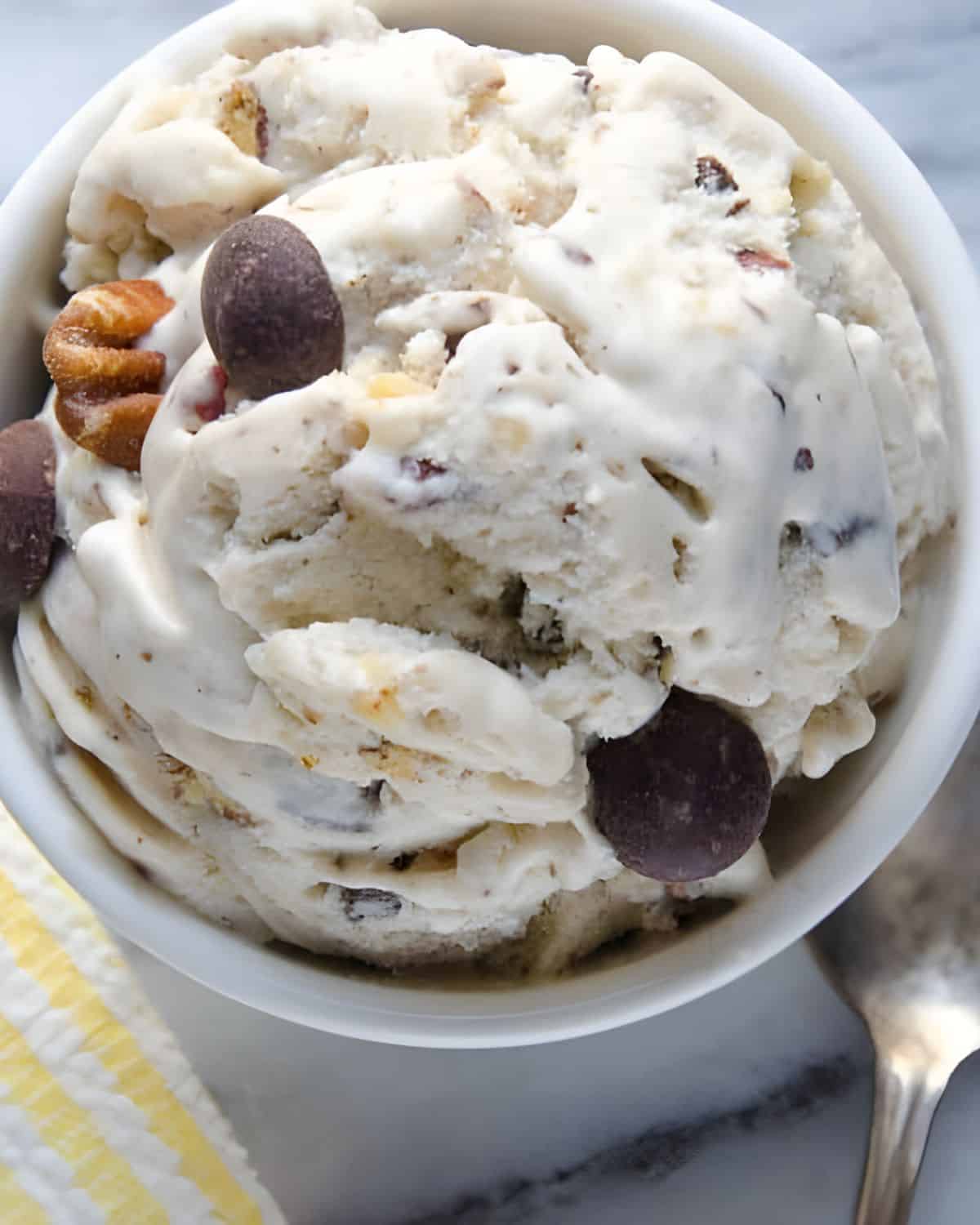 A dish of banana ice cream with chocolate chips.
