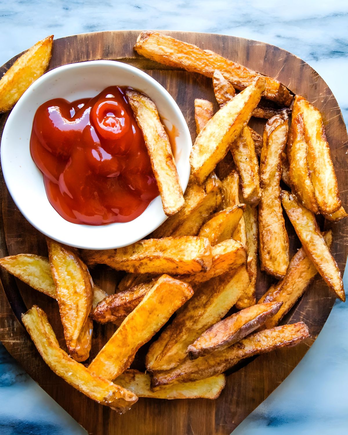 Homemade French fries with ketchup.