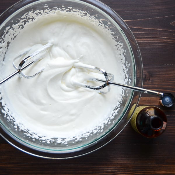  whipped cream with beaters in bowl.