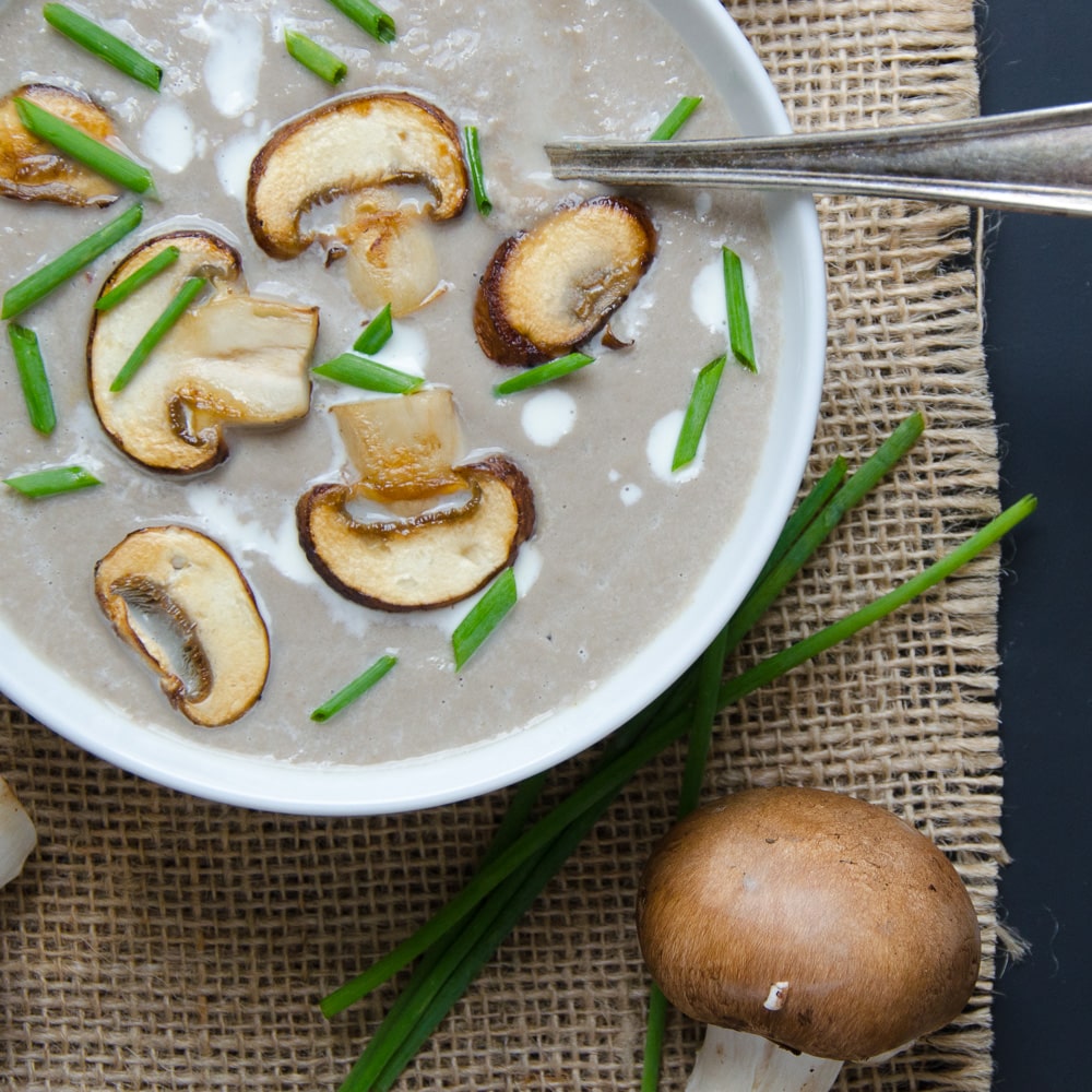 creamy mushroom bisque in a bowl with a spoon