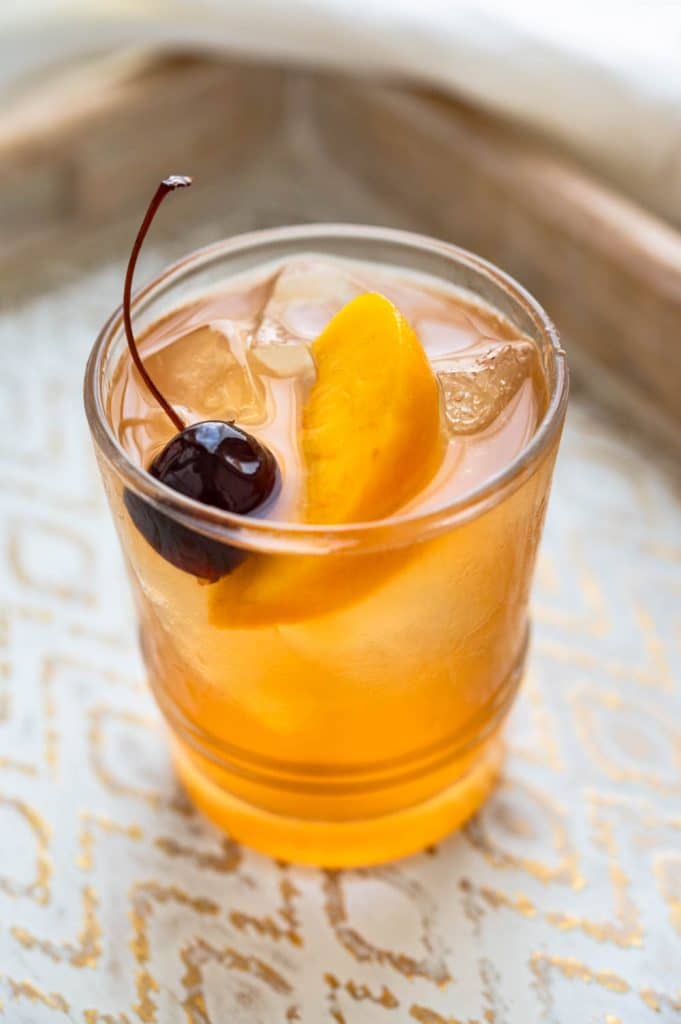 Fresh Peach Bourbon Sour in a cocktail glass.
