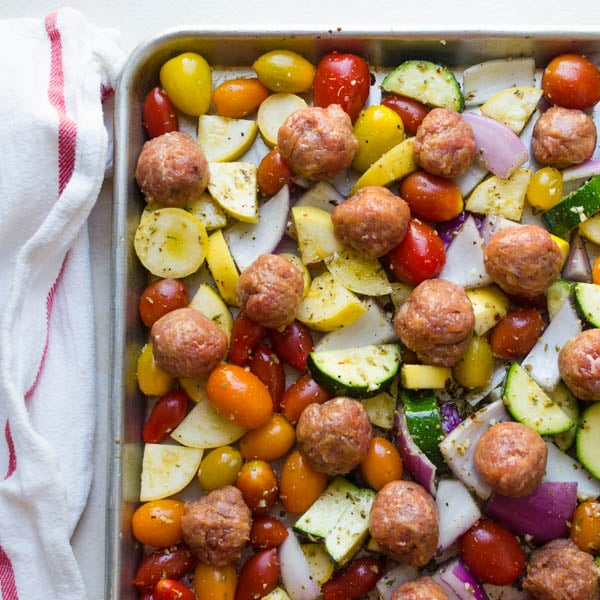vegetables and sausage on a sheet pan.