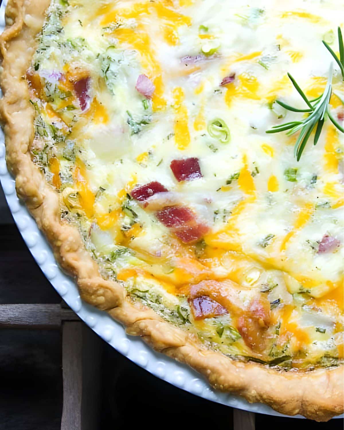 A loaded baked potato quiche with bacon and cheese.