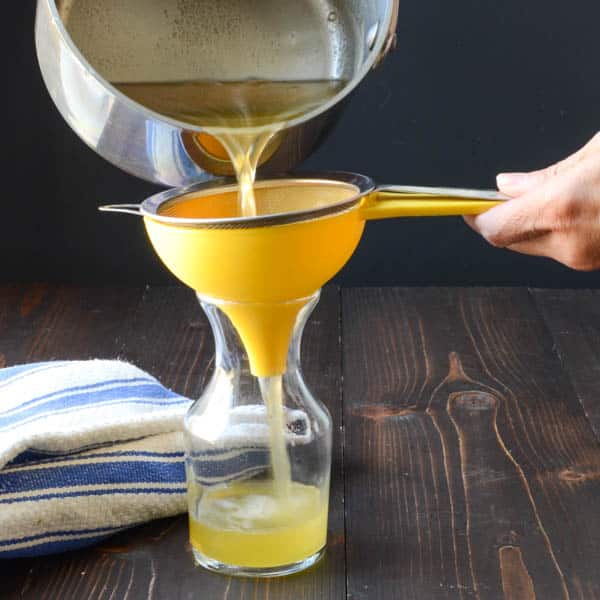 Straining Honey Thyme Simple Syrup 