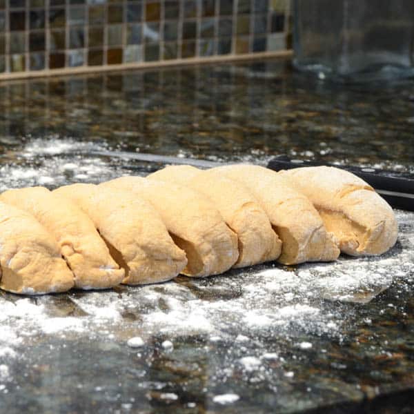 cutting dough into rolls