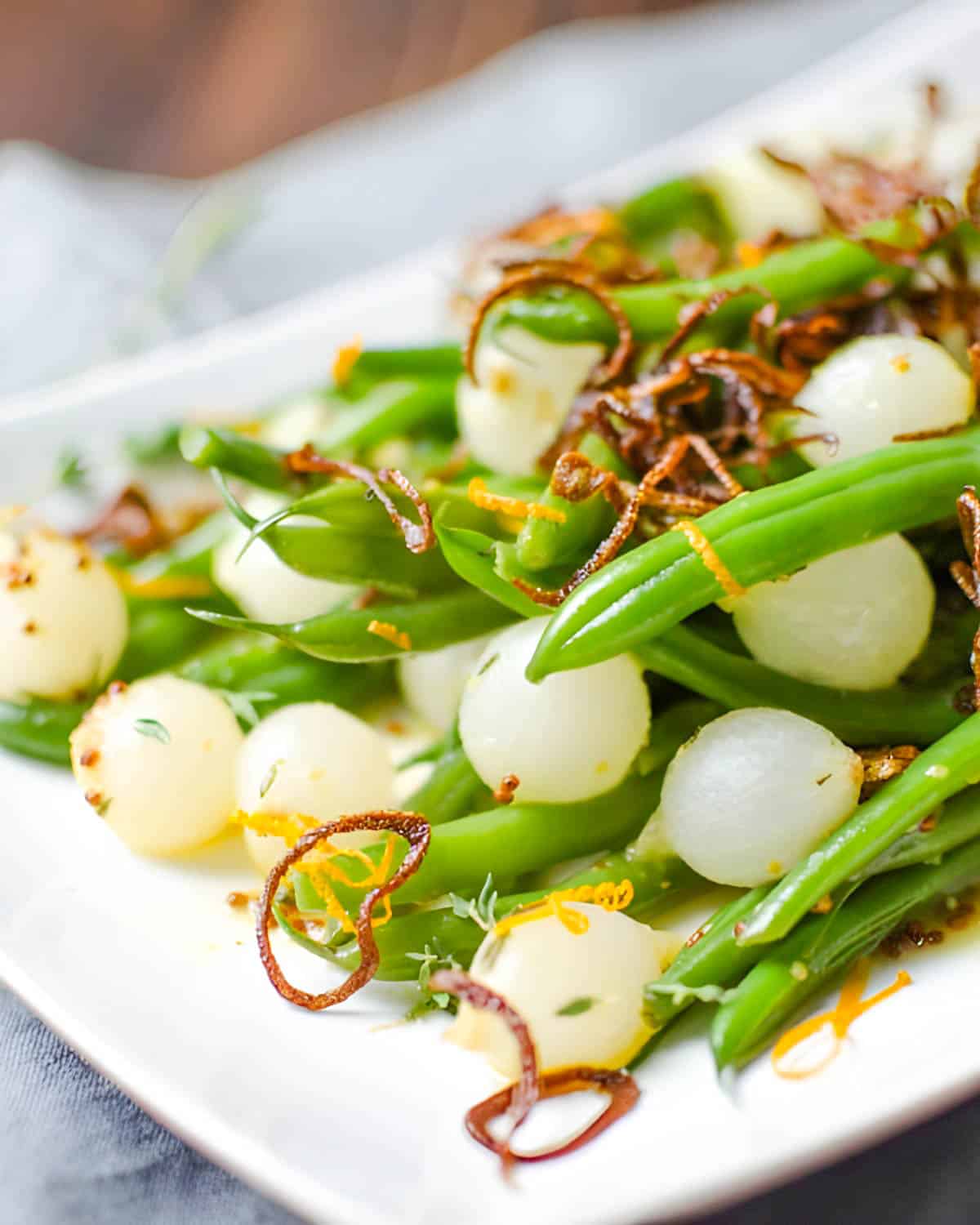 Haricots verts with pearl onions and crispy shallots.