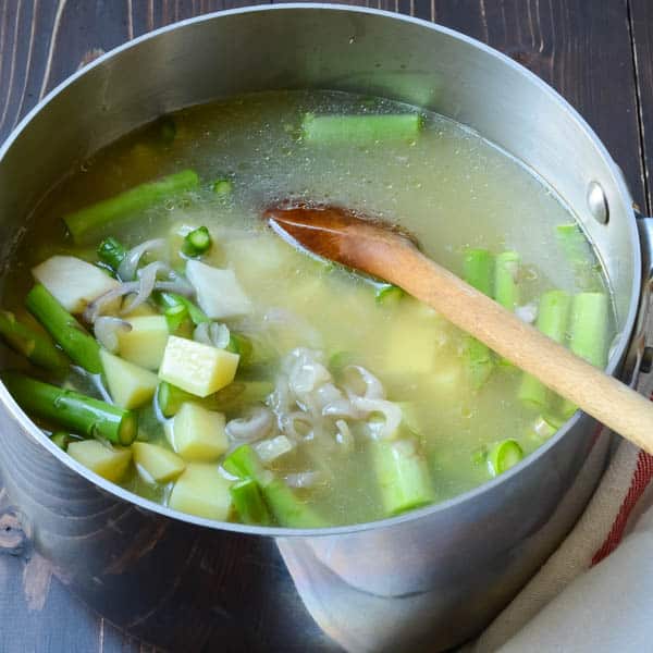 vegetables in broth with spoon