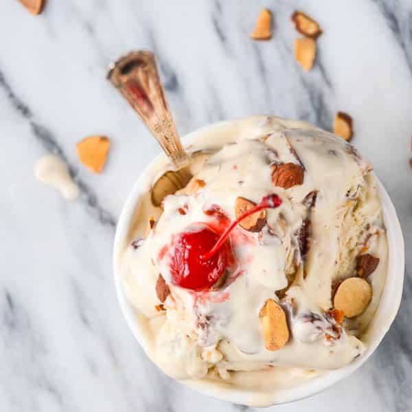 Cherry Amaretto Crunch Ice Cream in a bowl with toasted almonds and maraschino cherry.