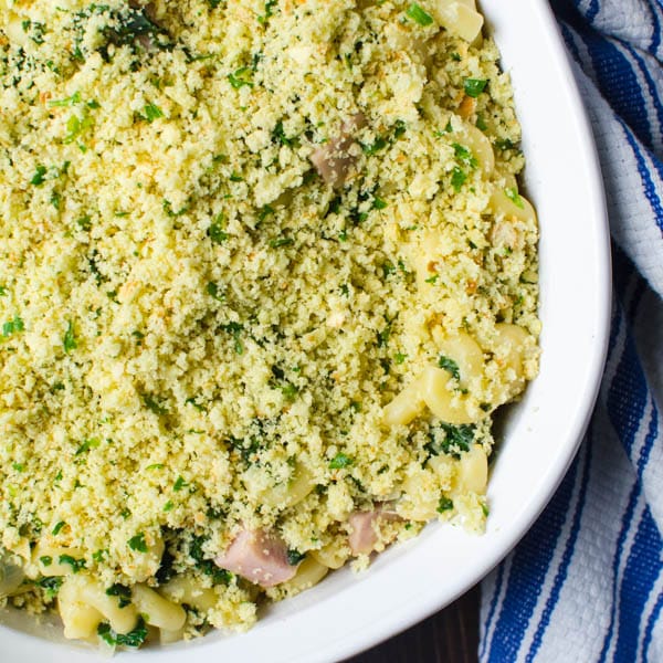 Topping Southern Ham and Kale Hot Dish with breadcrumbs.