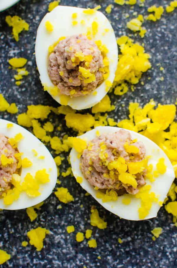 sprinkling egg appetizers with chopped yolks.