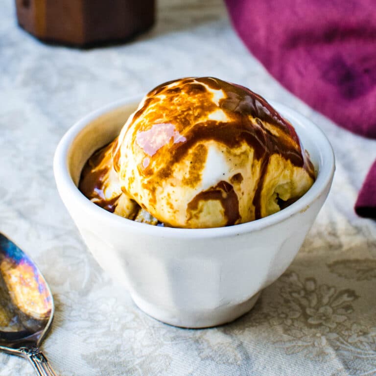 a bowl of ice cream with stout caramel sauce.